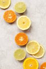 Sliced citrus fruits on table — Stock Photo