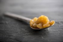 Manzana chutney en cuchara sobre la superficie gris - foto de stock