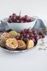 Grapes with figs and passion fruit — Stock Photo