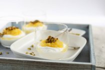 Yogurt with mango and pistachio — Stock Photo
