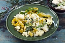Tagliatelle pasta with cauliflower and rocket — Stock Photo
