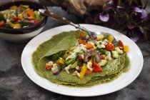 Green crepes with vegetables — Stock Photo