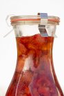 Closeup view of strawberry vinegar in a preserving bottle — Stock Photo