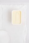 Вид сверху на пластиковую ванну с маргарином на белой ткани — стоковое фото