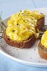 Closeup view of Crostini with scrambled egg and herbs — Stock Photo