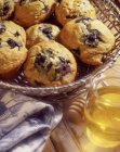 Blueberry muffins and jar of honey — Stock Photo