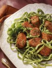 Sausages and spinach pasta — Stock Photo