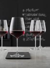 Closeup view of red wine in stemmed glasses — Stock Photo