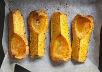 Closeup top view of roasted butternut squash on baking paper — Stock Photo