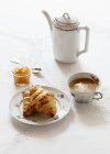 Croissants with glass of apricot jam — Stock Photo