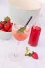 Champagne with ice and rhubarb and strawberry syrup — Stock Photo