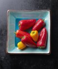 Fresh mini peppers in turquoise bowl — Stock Photo