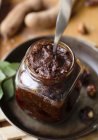 Closeup view of Tamarind Chutney in jar with spoon — Stock Photo