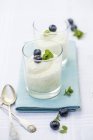 Closeup view of vanilla cream with blueberries and mint — Stock Photo