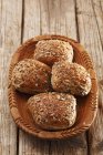 Seeded rolls in wooden bowl — Stock Photo