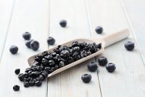 Dried blueberries on wooden scoop — Stock Photo