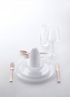 Elevated view of a white place setting with copper cutlery — Stock Photo
