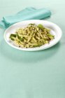 Strozzapreti pasta with anchovy pesto — Stock Photo