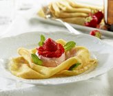 Closeup view of crepes with strawberry tartlet — Stock Photo
