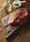 Raw beef fillet on wooden board — Stock Photo