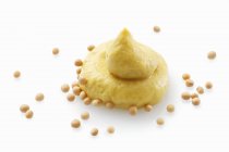 Dollop of mustard and seeds — Stock Photo