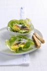 Closeup view of herring with scrambled egg on lettuce leaves — Stock Photo
