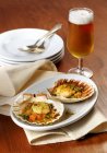 Gratinated scallops and beer — Stock Photo