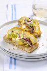 Crostini with anchovies and oranges  on white plate — Stock Photo
