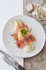 White asparagus with scrambled egg, Parma ham and truffles  on white plate — Stock Photo