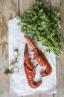 Top view of cooked halved lobster with fresh coriander and champagne cork — Stock Photo