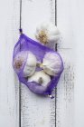 Bulbs of garlic in net — Stock Photo
