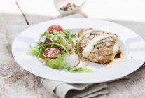 Grilled turkey breast with sauce and salad — Stock Photo