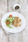 Grilled turkey breast with sauce and salad — Stock Photo