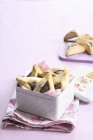 Closeup view of Hamantaschen poppy seed filled pastries in tin box — Stock Photo