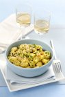 Gnocchi al rag di mare gnocchi with seafood ragout, pistachios and sesame seeds in bowl over towel — Stock Photo
