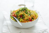 Three-colored fusilli pasta with vegetables — Stock Photo