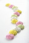 Colorful meringues on a white surface — Stock Photo