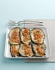 Melanzane al for no oven-roasted aubergines on white plate — стоковое фото