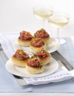 Elevated view of Pane condito con cotechino rolls topped with raw sausage meat — Stock Photo
