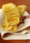 Dry uncooked tagliatelle pasta — Stock Photo