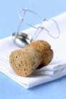 Closeup view of Champagne cork and a wire cork holder — Stock Photo