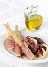 Bread sticks with ham and radicchio salad — Stock Photo
