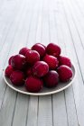 Fresh plums on plate — Stock Photo