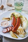 Sausages with grilled vegetables — Stock Photo