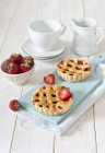 Strawberry tartlets on cutting board — Stock Photo