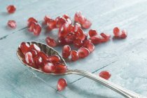Spoon with pomegranate seeds — Stock Photo