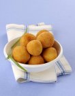 Round croquettes  on white plate over towel on blue background — Stock Photo