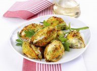 Stuffed courgette flowers in white plate over towel — Stock Photo