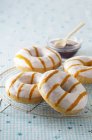 Doughnuts with icing and caramel stripes — Stock Photo