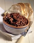 Caviale di Crucoli anchovy paste with chilli and peel seeds inbowl over towel — стоковое фото